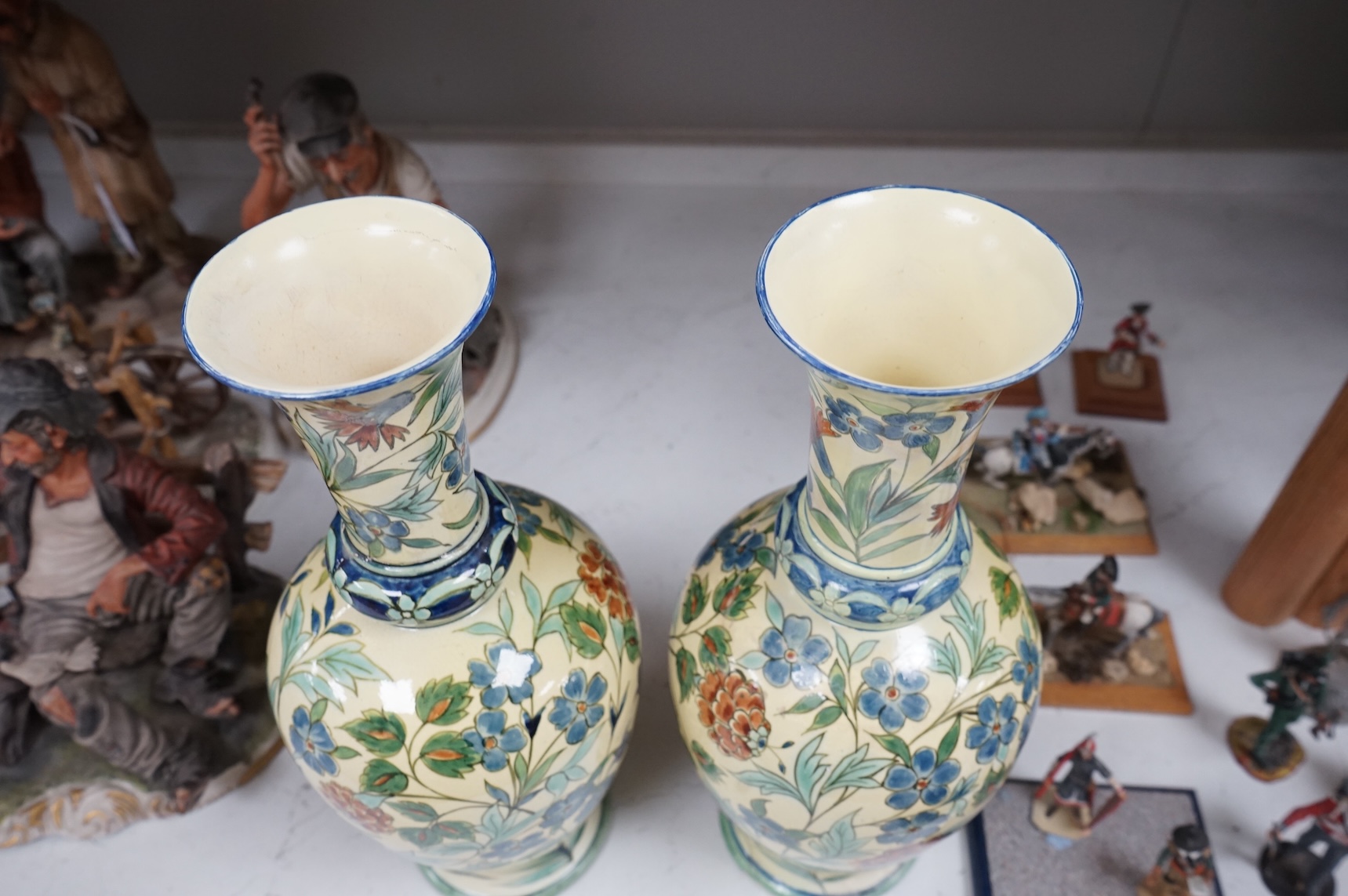 A pair of Doulton Lambeth Persian inspired faience vases, dated 1877, restored, 37cm high